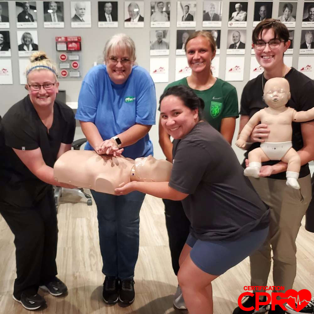 CPR training class in Orlando with students practicing on mannequins.